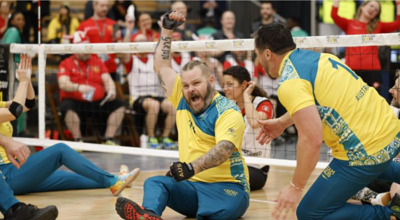 Luke Manhire celebrating at a seated volleyball match.