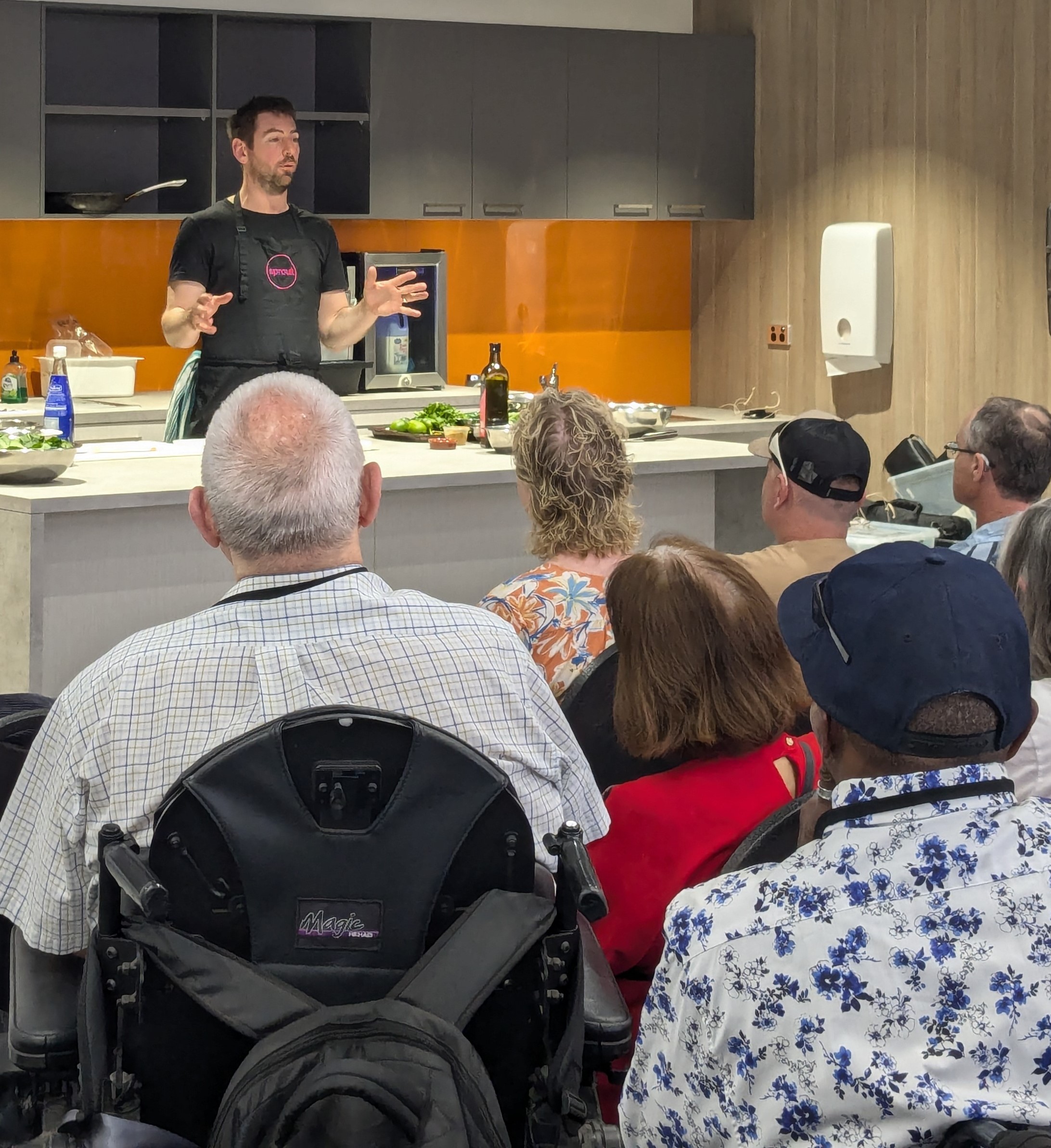 Chef Callum Hann speaking in front of an audience.